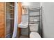 Quaint bathroom with wood shower, pedestal sink, toilet and storage rack at 6050 Marshall Ct, Arvada, CO 80003