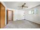 Bright bedroom features neutral carpet, a ceiling fan, closet, and natural light from the window at 6050 Marshall Ct, Arvada, CO 80003