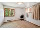 Carpeted bedroom with large window, ceiling fan, and neutral walls at 6050 Marshall Ct, Arvada, CO 80003