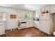 Functional kitchen with white appliances and cabinets, plus a window over the sink at 6050 Marshall Ct, Arvada, CO 80003