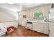Practical kitchen space with white cabinets, linoleum floors, and back door access at 6050 Marshall Ct, Arvada, CO 80003