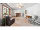 Spacious living room featuring a brick fireplace, ceiling fan, and natural light at 6050 Marshall Ct, Arvada, CO 80003