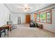 Bright living room featuring a ceiling fan, a bay window, and neutral carpet at 6050 Marshall Ct, Arvada, CO 80003