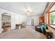 Open living room with views to kitchen showcasing a vintage ceiling fan and carpet floors at 6050 Marshall Ct, Arvada, CO 80003