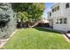 Spacious backyard featuring lush green grass and a patio area, perfect for outdoor entertaining at 521 N Fairfax St, Denver, CO 80220