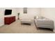 Finished basement with comfortable seating, modern entertainment, and neutral decor at 521 N Fairfax St, Denver, CO 80220