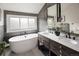 Beautiful bathroom featuring a soaking tub, dual sinks, and natural light creates a serene and stylish space at 521 N Fairfax St, Denver, CO 80220
