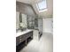 Modern bathroom features dual sinks, a glass shower, and a skylight for a bright, airy feel at 521 N Fairfax St, Denver, CO 80220