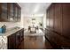 Open dining room with dark hardwood floors and granite countertops adjacent to custom wood cabinets at 521 N Fairfax St, Denver, CO 80220