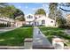Stunning home featuring a meticulously manicured front yard, a lovely walkway, and a charming dog at 521 N Fairfax St, Denver, CO 80220