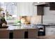 Modern kitchen featuring stainless steel appliances, granite countertops, and custom cabinetry at 521 N Fairfax St, Denver, CO 80220