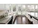Bright kitchen area with granite countertop, stylish desk nook, and French doors to the backyard at 521 N Fairfax St, Denver, CO 80220