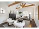 Cozy living room with vaulted ceilings, wood beams, fireplace, and ample natural light at 521 N Fairfax St, Denver, CO 80220