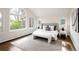 Sun-filled main bedroom with vaulted ceilings, large windows, and hardwood floors provides a relaxing retreat at 521 N Fairfax St, Denver, CO 80220