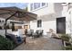 Cozy patio featuring plush seating, an umbrella for shade, and convenient access to the home's entrance at 521 N Fairfax St, Denver, CO 80220