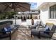 Inviting outdoor patio with stylish seating, a large umbrella, and a view of the basketball hoop in the backyard at 521 N Fairfax St, Denver, CO 80220