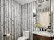 Charming powder room with unique wallpaper, vanity, and elegant fixtures at 521 N Fairfax St, Denver, CO 80220