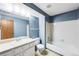 A full bathroom with vanity and sink, toilet, and shower over tub at 4896 S Dudley St # 4-7, Littleton, CO 80123