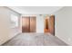 Bedroom showcasing neutral walls, plush gray carpet, and closet with sliding doors at 4896 S Dudley St # 4-7, Littleton, CO 80123