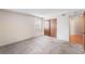 This bedroom has neutral walls, gray carpet, a window, and a large closet at 4896 S Dudley St # 4-7, Littleton, CO 80123