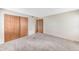 Cozy bedroom featuring neutral walls, gray carpet, and a closet with sliding doors at 4896 S Dudley St # 4-7, Littleton, CO 80123