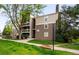 Multi-level apartment building featuring two-tone siding, balconies, and well-maintained landscaping at 4896 S Dudley St # 4-7, Littleton, CO 80123