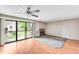 A spacious living room with hardwood floors, large windows, and a cozy fireplace at 4896 S Dudley St # 4-7, Littleton, CO 80123