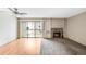 A bright living room featuring hardwood floors, a sliding glass door, and a lovely fireplace at 4896 S Dudley St # 4-7, Littleton, CO 80123