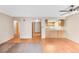 Open living room showcasing hardwood floors, a ceiling fan, and view into the kitchen at 4896 S Dudley St # 4-7, Littleton, CO 80123