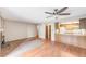 Open living room with hardwood floors flowing into a kitchen area at 4896 S Dudley St # 4-7, Littleton, CO 80123