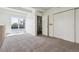 Bright bedroom featuring sliding glass doors and double closets for ample storage space at 384 S Ironton St # 413, Aurora, CO 80012