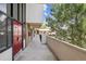 Exterior walkway featuring a red door and lush landscaping, creating a welcoming entrance at 384 S Ironton St # 413, Aurora, CO 80012