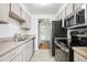 Galley kitchen featuring stainless steel appliances and tile flooring at 384 S Ironton St # 413, Aurora, CO 80012