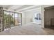 Bright room with neutral carpet and stone accent wall, offering views of the outdoors through expansive windows at 384 S Ironton St # 413, Aurora, CO 80012
