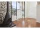 Bright living room with a stone accent wall, wood floors, a fireplace, and lots of natural light at 384 S Ironton St # 413, Aurora, CO 80012