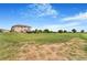 Large backyard featuring expansive lawn and a playset under a blue sky at 17635 Silver Fox Ct, Mead, CO 80542