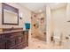 Bathroom featuring a frameless glass shower, dark wood vanity and neutral finishes at 17635 Silver Fox Ct, Mead, CO 80542