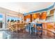 Dining room and kitchen with wooden cabinets, island and custom table at 17635 Silver Fox Ct, Mead, CO 80542