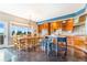 Dining room and kitchen with wooden cabinets, island and custom table at 17635 Silver Fox Ct, Mead, CO 80542