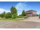 Home exterior featuring mature trees and a three-car garage at 17635 Silver Fox Ct, Mead, CO 80542