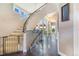 Grand foyer featuring a curved staircase with iron railing and ample natural light at 17635 Silver Fox Ct, Mead, CO 80542