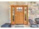 Elegant front door with sidelights and decorative glass on a stone facade at 17635 Silver Fox Ct, Mead, CO 80542