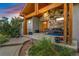Inviting stone-accented front porch with wood beams and cozy seating area at 17635 Silver Fox Ct, Mead, CO 80542