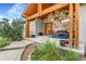 Inviting front porch with stone accents, a seating area, and well-manicured landscaping at 17635 Silver Fox Ct, Mead, CO 80542