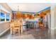 Dining room and kitchen with wooden cabinets, stainless appliances, and island at 17635 Silver Fox Ct, Mead, CO 80542