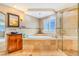 Luxurious main bathroom featuring a soaking tub, separate shower, and elegant finishes at 17635 Silver Fox Ct, Mead, CO 80542
