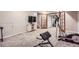 Finished basement with a TV, neutral carpet, and exercise equipment, perfect for entertaining at 11481 King St, Westminster, CO 80031