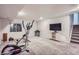 Well-lit basement area with TV and exercise equipment, offering flexible space for recreation at 11481 King St, Westminster, CO 80031