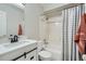 Bright bathroom features a white vanity, toilet, and shower-tub combo with modern finishes at 11481 King St, Westminster, CO 80031
