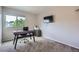 Comfortable bedroom area with neutral walls, soft carpet, and a large window for ample natural light at 11481 King St, Westminster, CO 80031